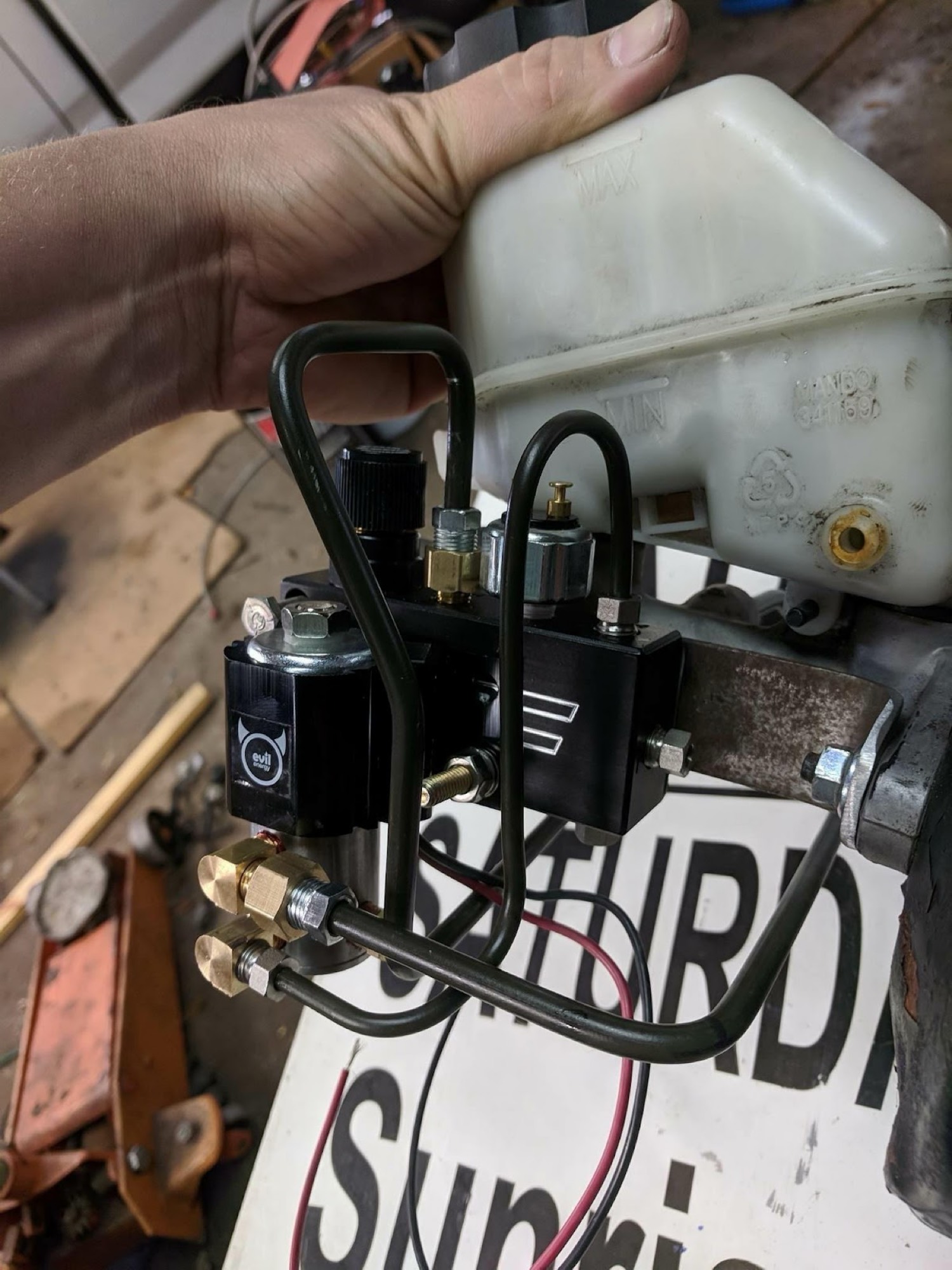 Hand holding ABS delete master cylinder assembly