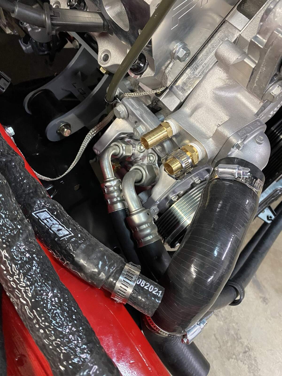 Close-up of A/C compressor fittings and hard lines