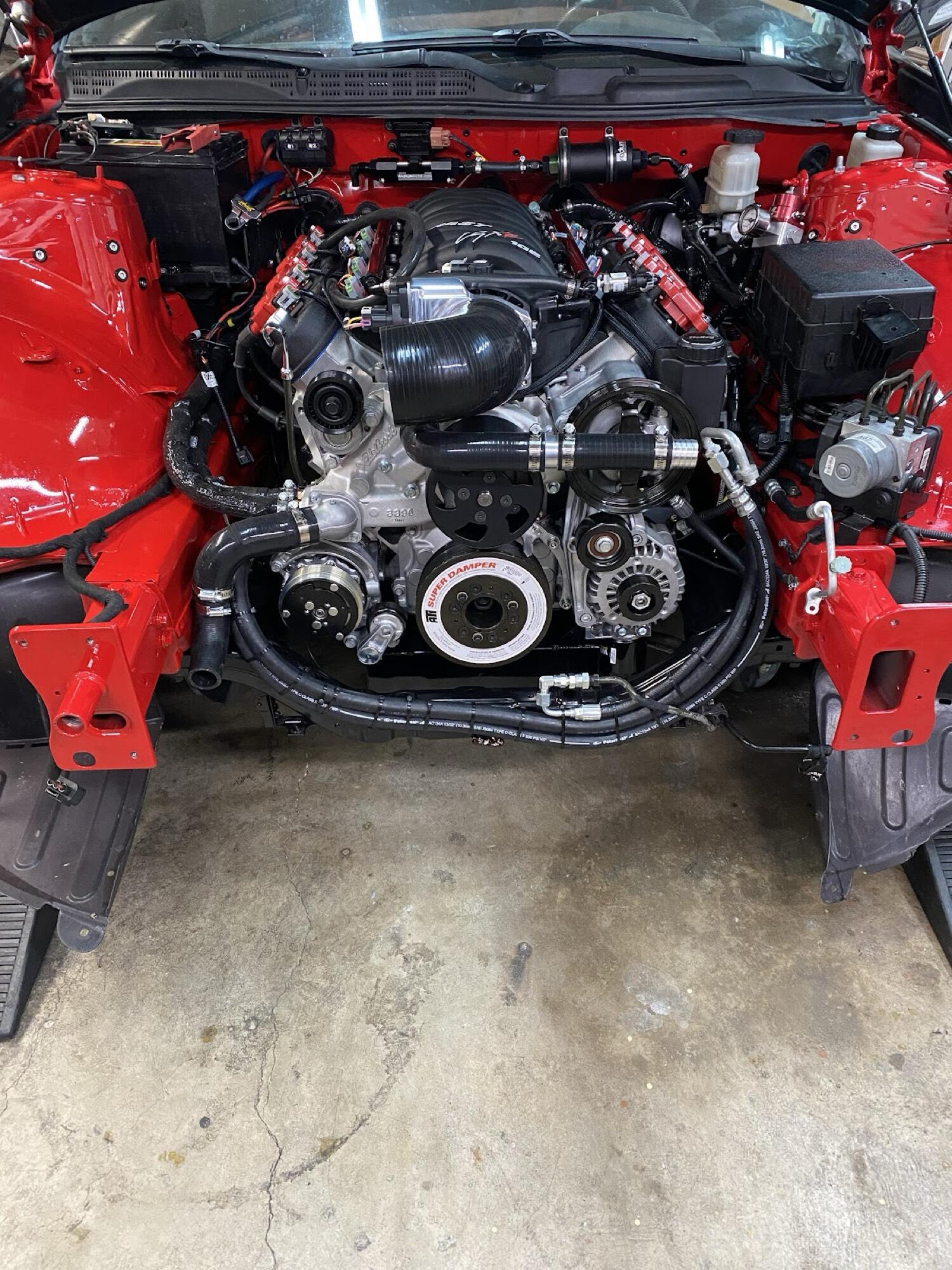 LS swapped red Genesis Coupe engine bay with A/C compressor