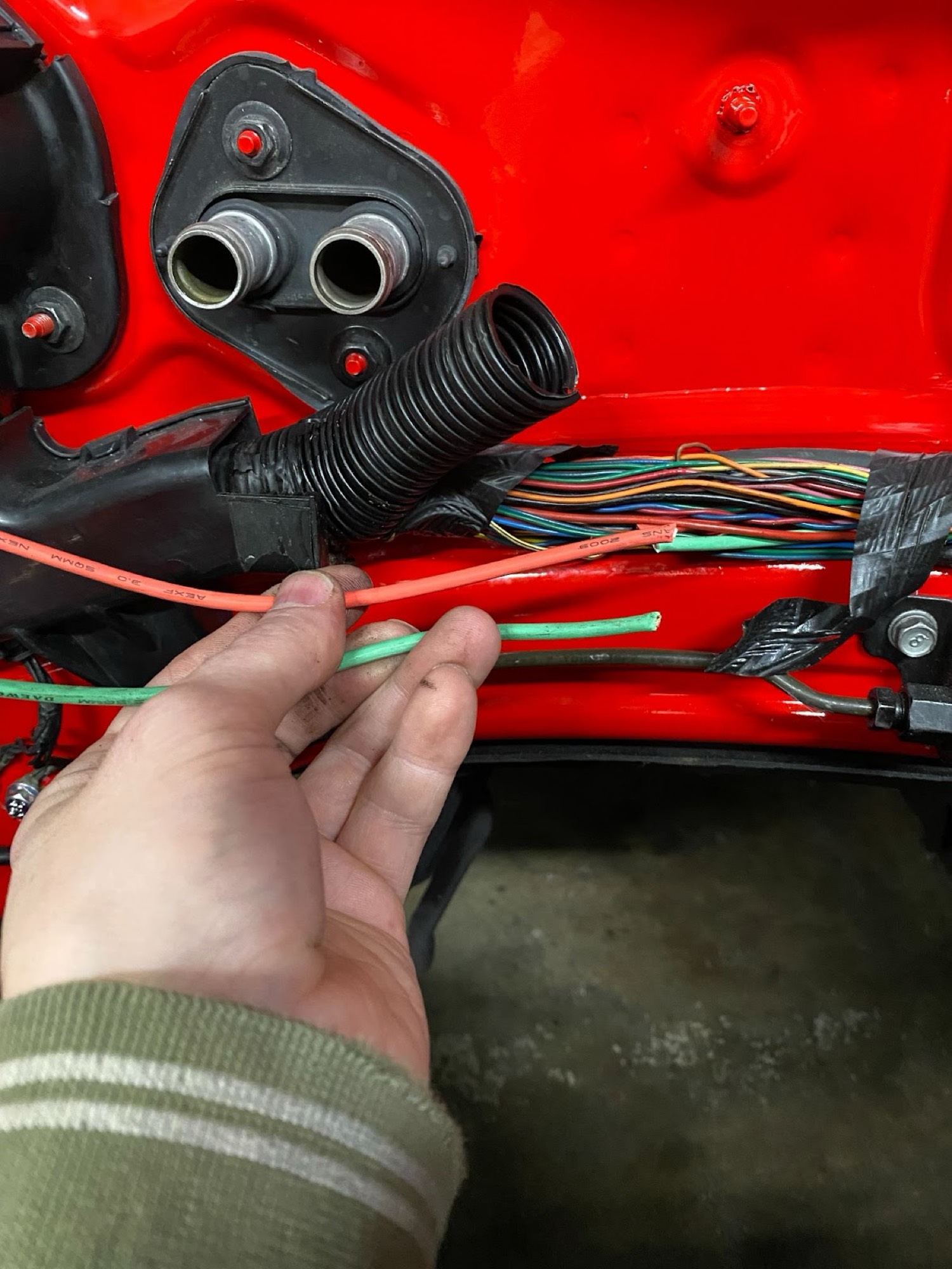 Red and green factory fan wires pulled from firewall bulkhead