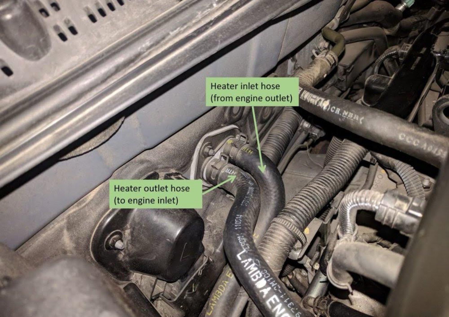 Heater core inlet and outlet ports labeled at firewall
