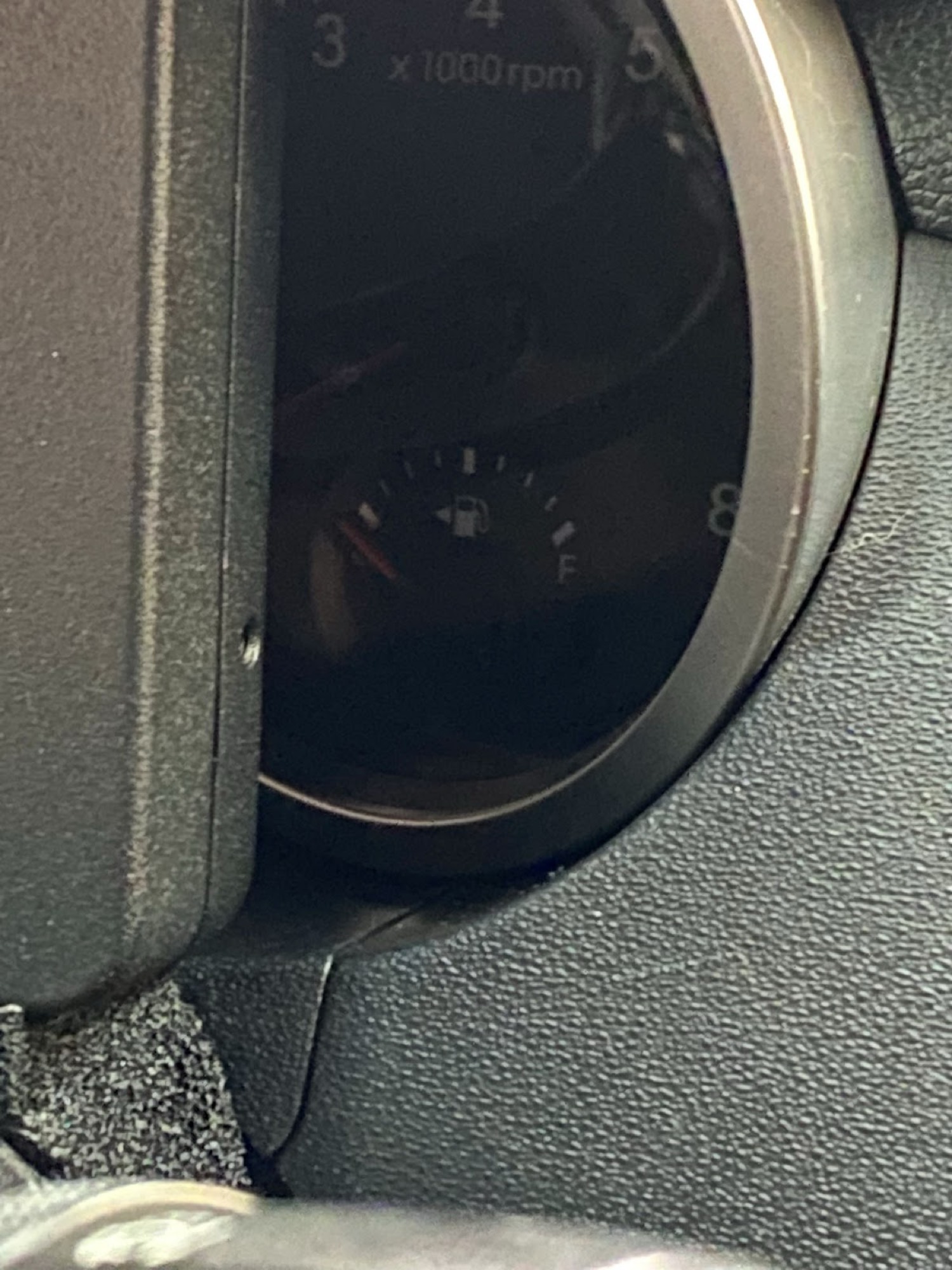 OEM fuel gauge still visible behind Holley dash